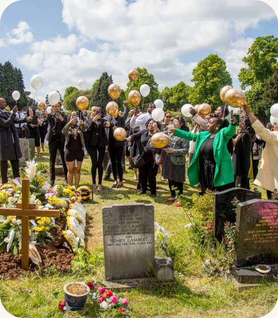 An outdoor funeral service being live streamed